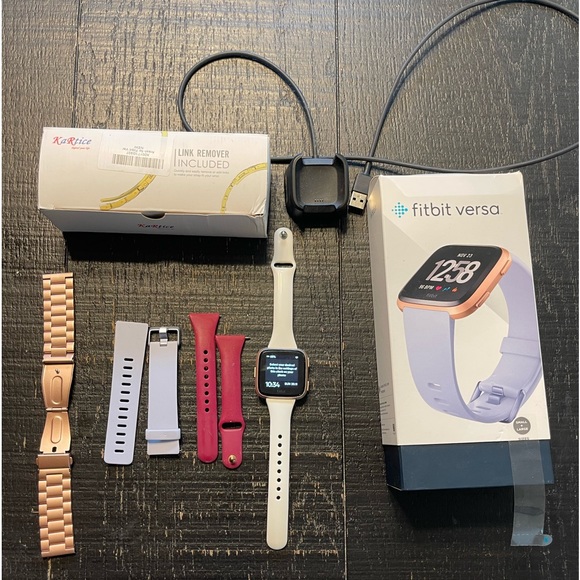 Fitbit Versa Rose Gold with several bands